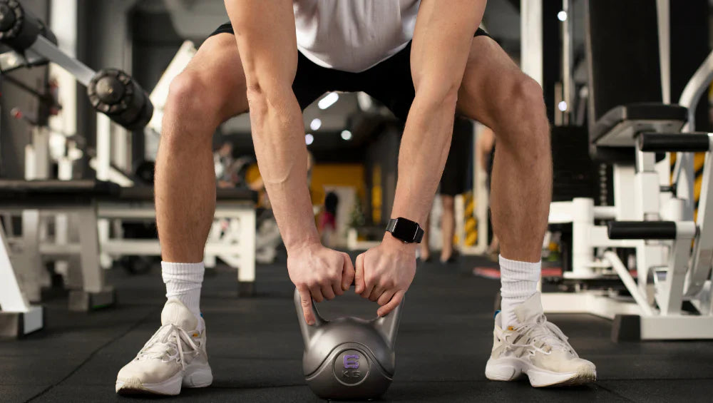 Photo d'un homme qui fait un exercice de sport avec une kettlebells.