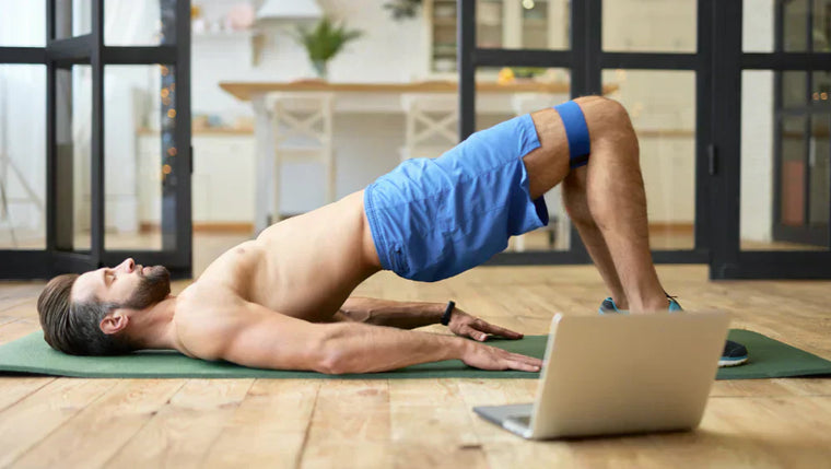 Homme athlétique en train de faire un exercice fessier dans son salon